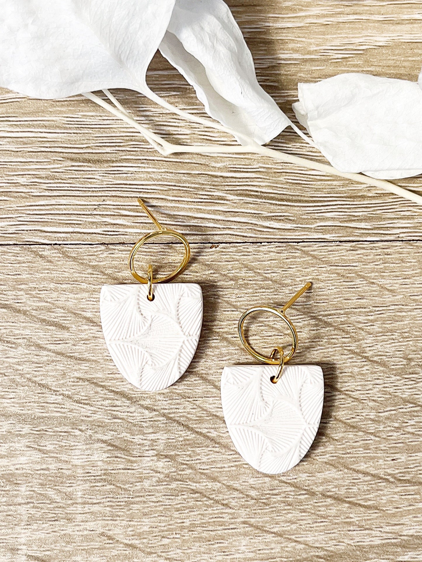 Gold stud earring with white textured inverted arch
