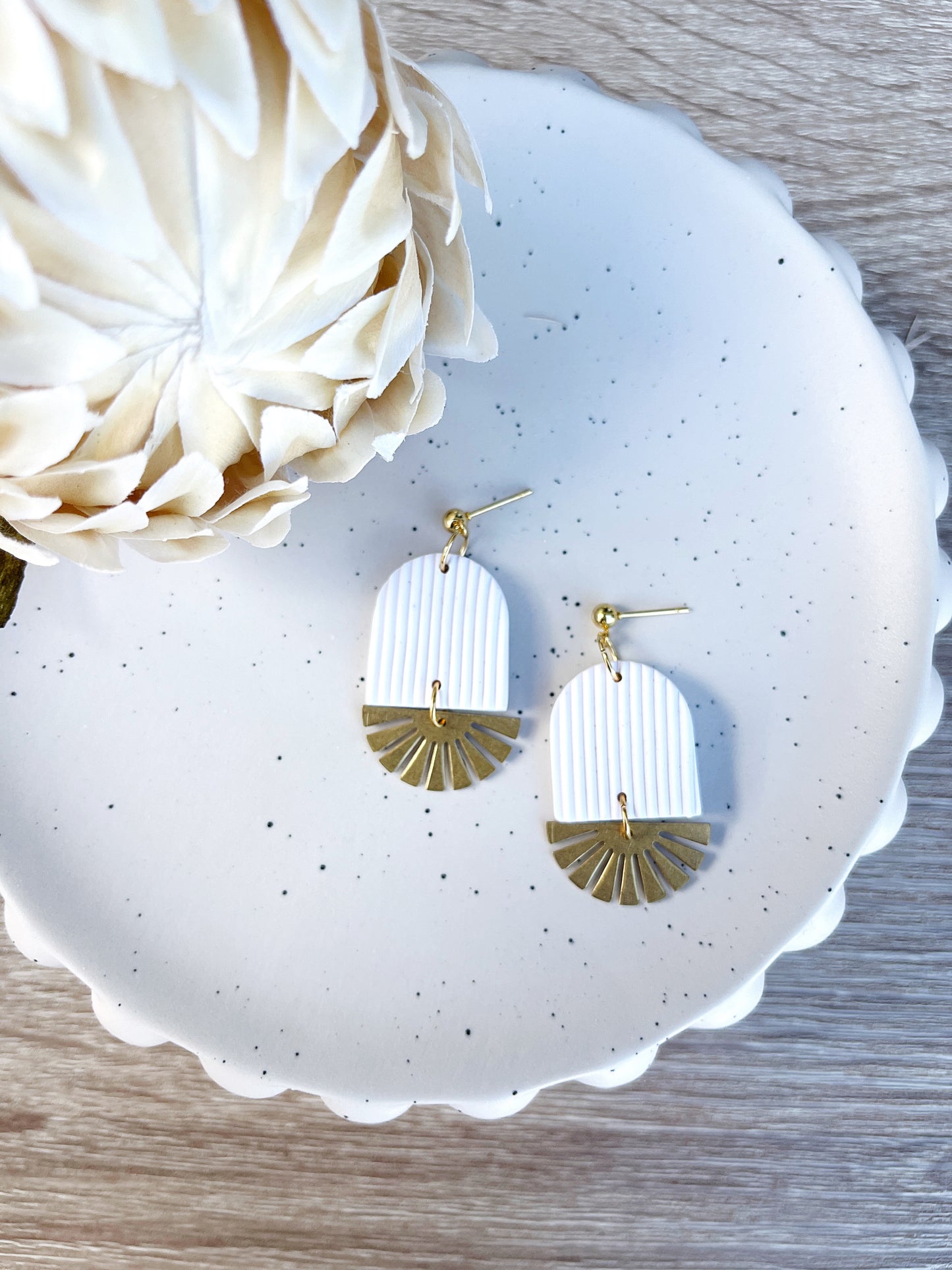 Gold and white arch earring with brass sun