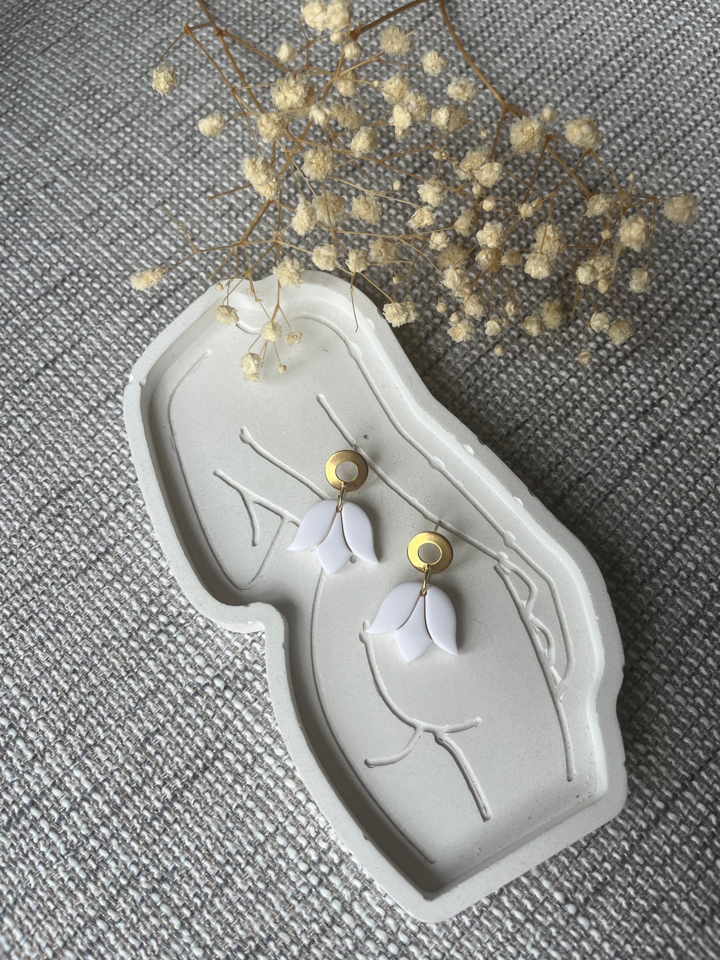 Gold stud earring with delicate white tulip design