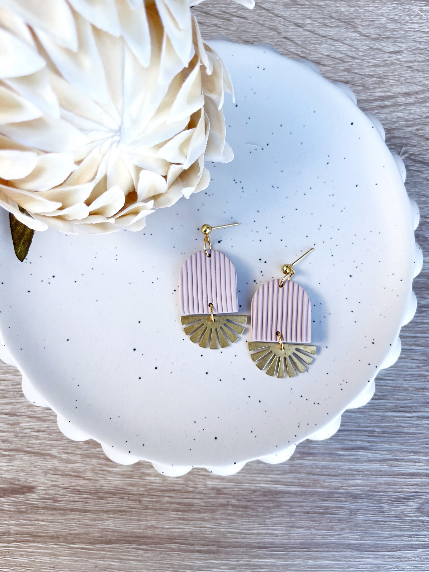 Gold and beige arch earring with brass sun