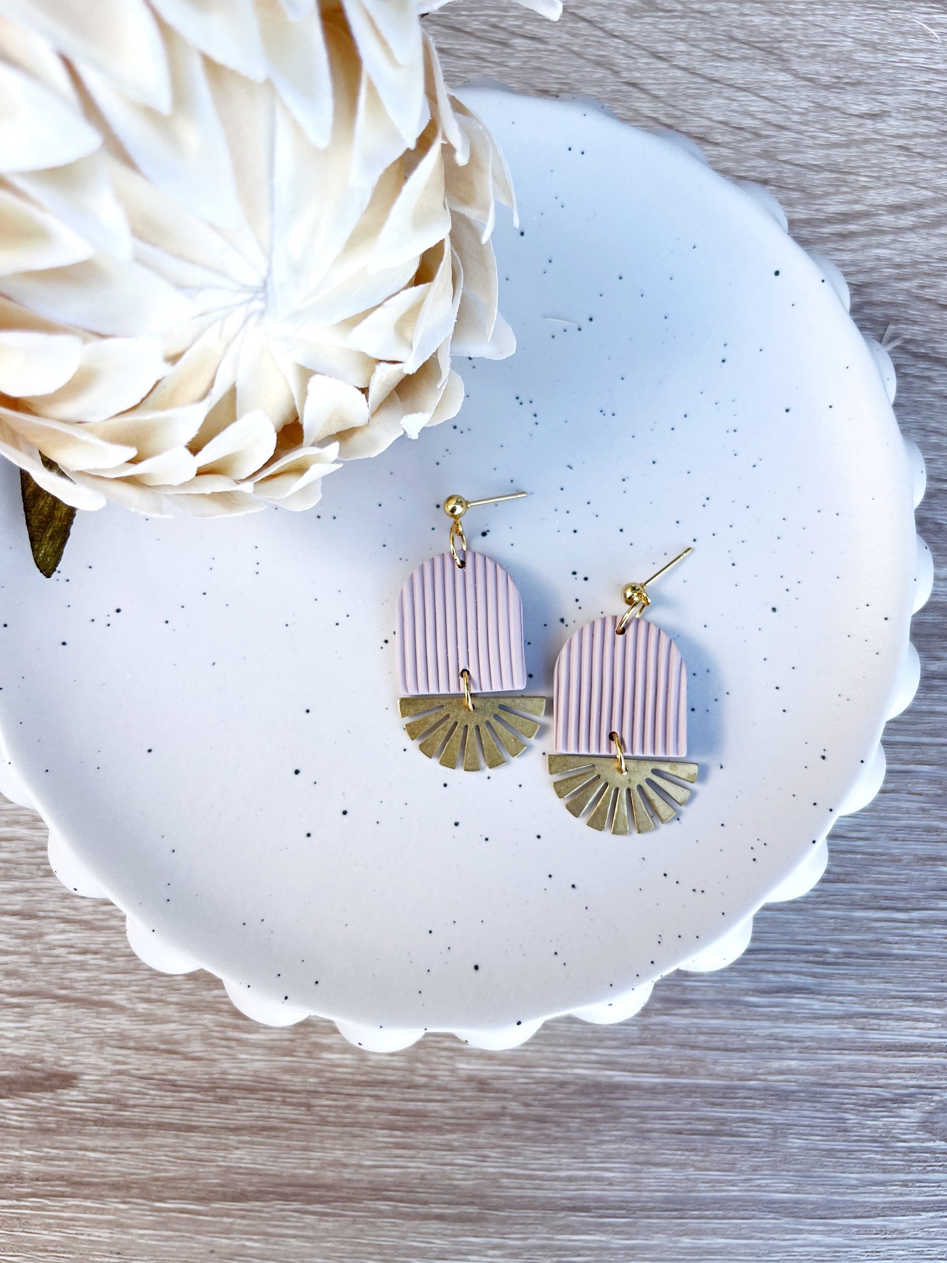 Gold and beige arch earring with brass sun