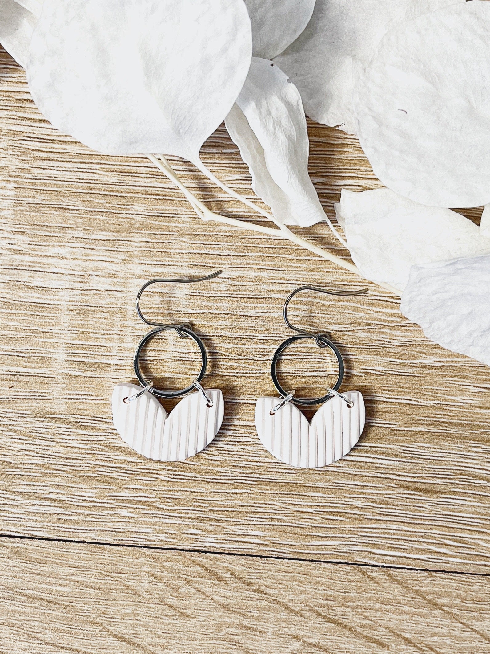 Silver hook earring with white heart shape