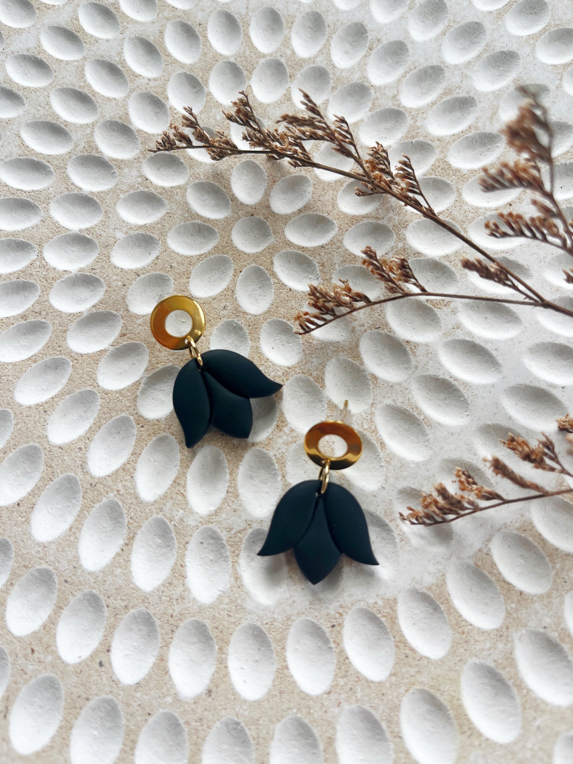 Gold stud earring with delicate black tulip design
